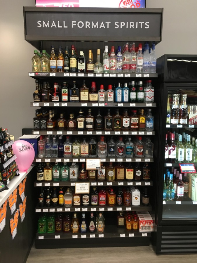 10. Large Format Liquor Store Wall Display with Lit Valence and Wood Ticket Channel