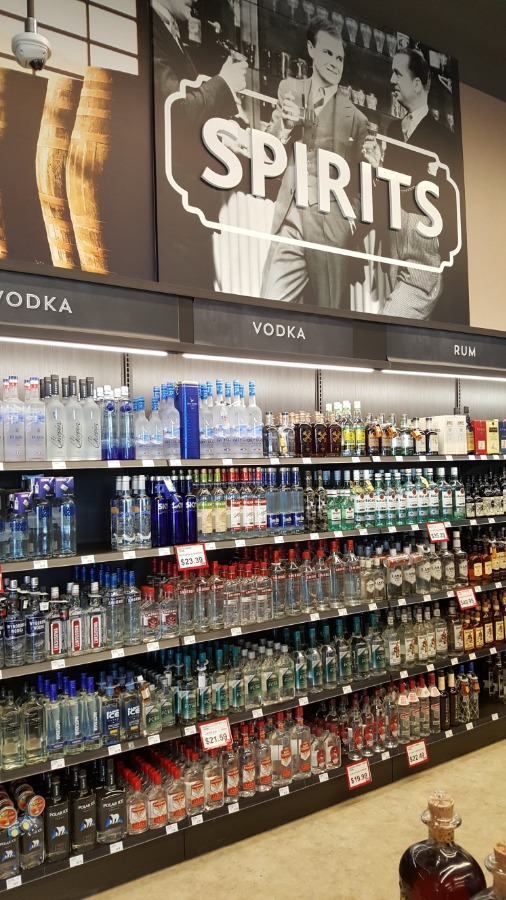 8. Large Format Liquor Store Wall Display with Lit Valence and Wood Ticket Channel